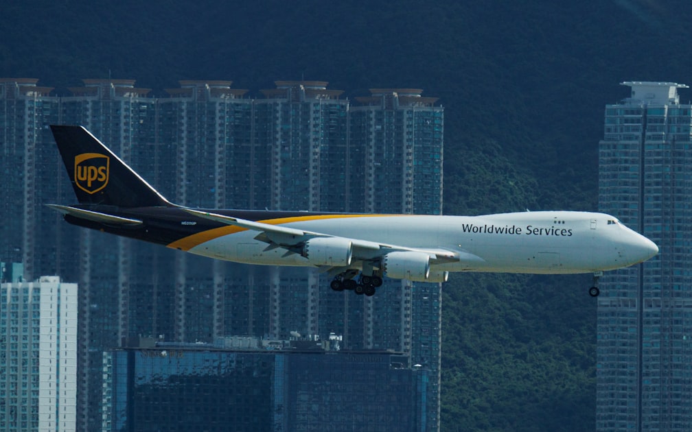 A ups cargo plane flies over city buildings — Hàng Gửi Bị Mất Bị Hư - Cách Khiếu Nại Viettel Post Hiệu Quả
