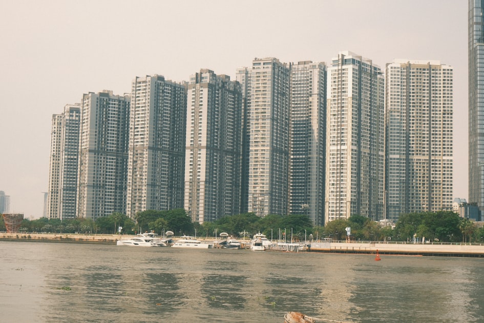 Modern high-rise apartment buildings line a waterfront with boats — Lắp Mạng Biệt Thự Shophouse Ocean Park