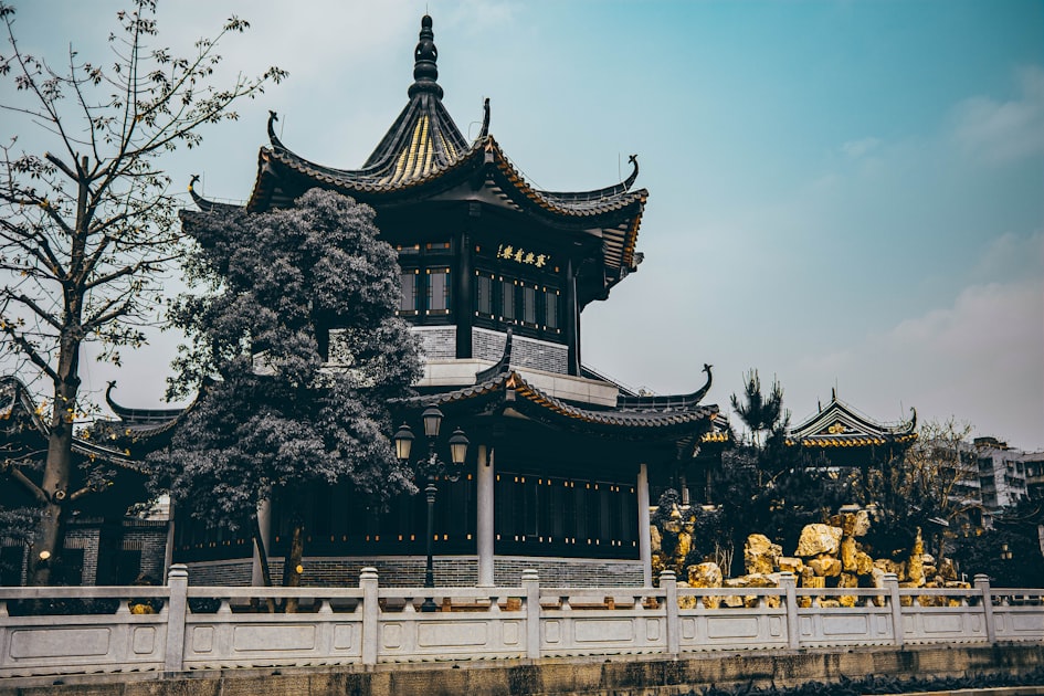 black and white temple near green trees during daytime — Quẻ Thiên Địa Bĩ - Luận Số Điện Thoại Kinh Dịch