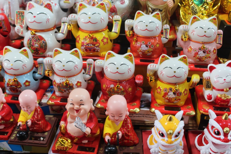 Row of lucky cat figurines and small monk statues — Sim ABAB: Ý Nghĩa, Mẫu Số & Cách Chọn Hợp Mệnh