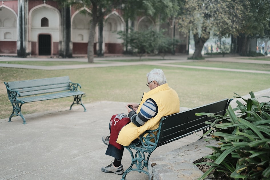 a man sitting on a bench in a park — Sim Đẹp Tặng Bố Mẹ & Người Lớn Tuổi — Hiếu Thảo, Dễ Nhớ