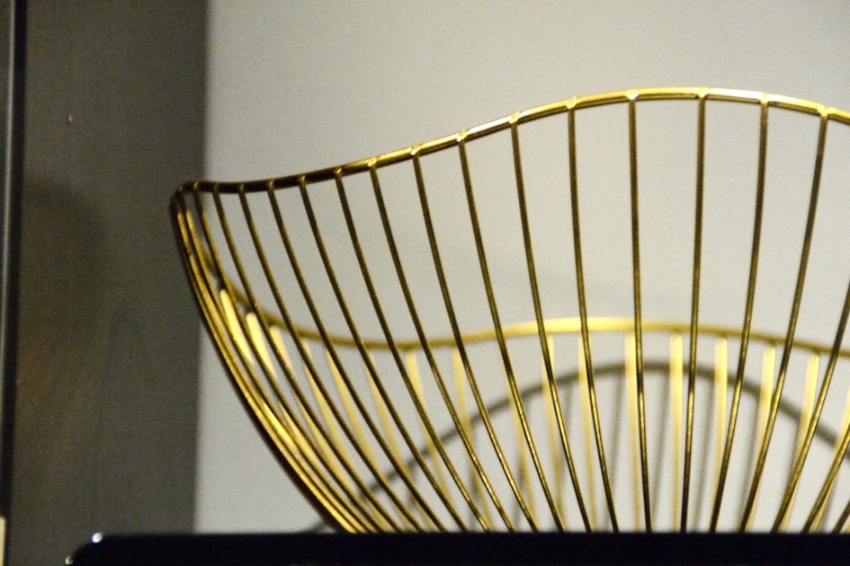 A golden wire fruit bowl on a shelf — Sim Hợp Mệnh Kim - Số May Mắn & Cách Chọn