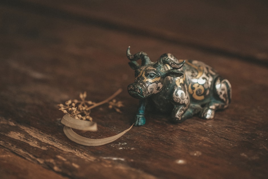 a small figurine of a cow on a wooden table — Sim Hợp Tuổi Mùi (Dê) - Số Đẹp & Mệnh