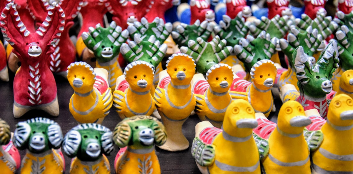 a group of ceramic animal figurines sitting on top of a table — Sim Hợp Tuổi Tuất (Chó) - Số Đẹp & Mệnh